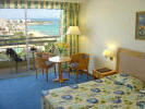 A standard bedroom at the Sunrise Beach Hotel